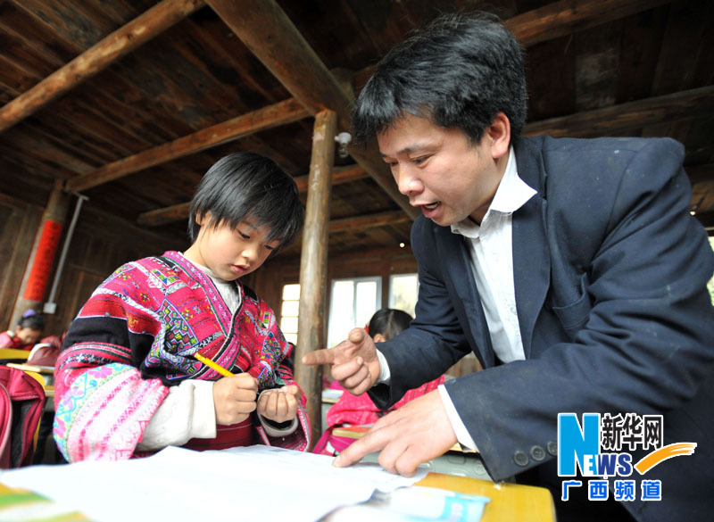 Yu Qigui tutors a student's study on Feb. 26, 2013. (Photo/Xinhua)