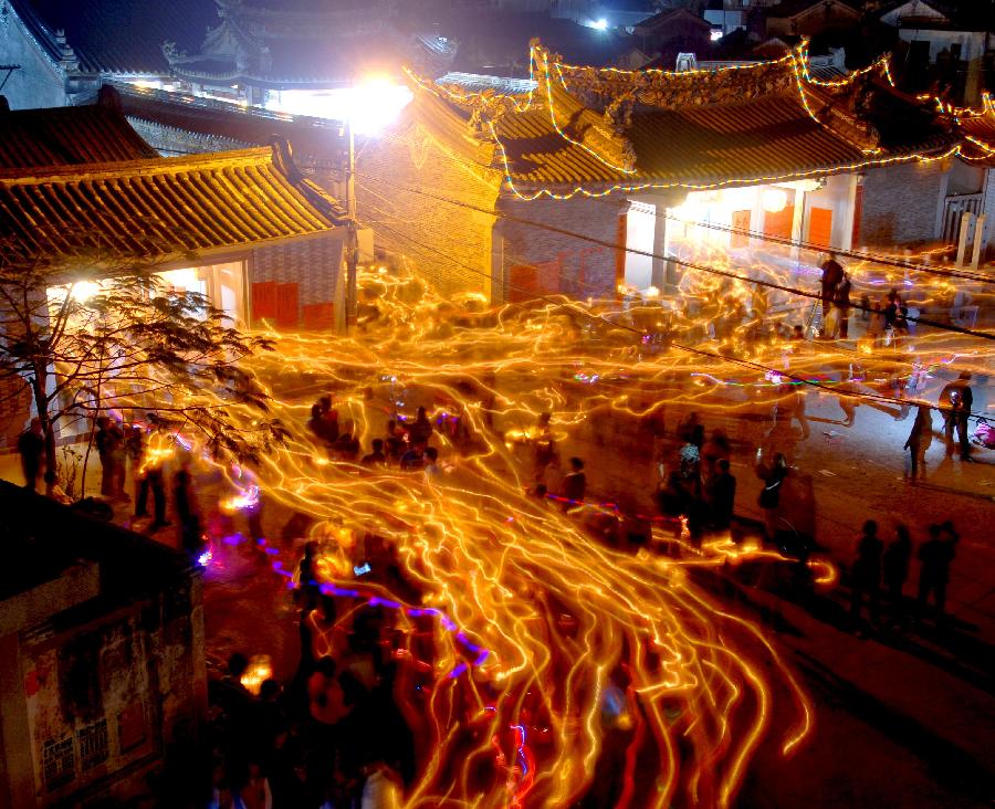 Residents attend an annual lantern parade in Nanshaxiang Village of Shantou, south China's Guangdong Province, Feb. 28, 2013. Participants of the festivity hold lanterns bearing their family names as they proceed through the village. They believe the village's lantern parade, which has existed for centuries, could bring good harvest and fortune. (Xinhua/Xu Ming)