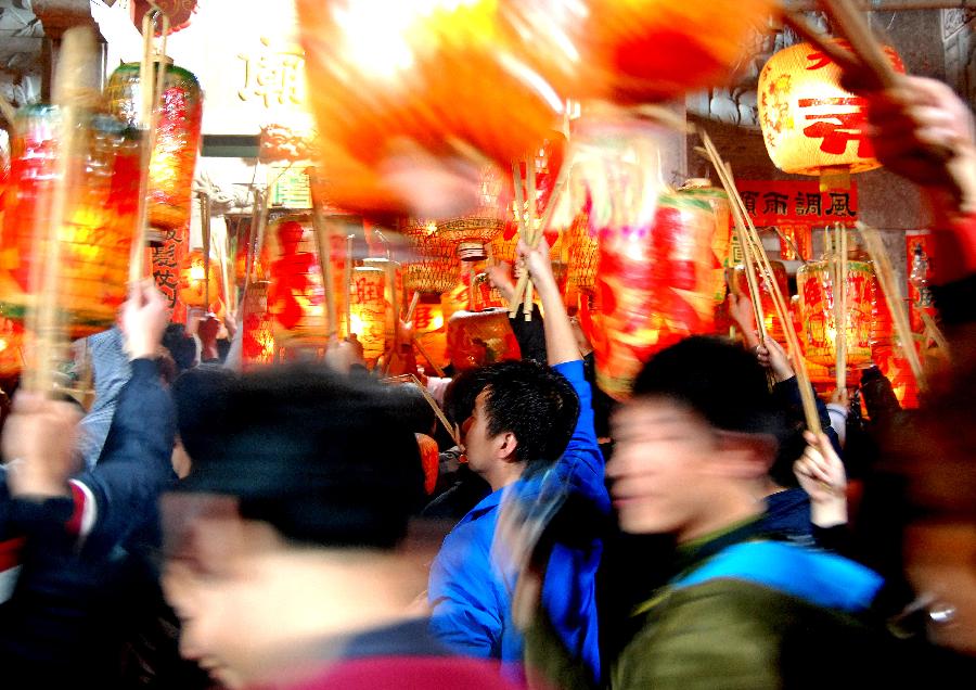 Residents attend an annual lantern parade in Nanshaxiang Village of Shantou, south China's Guangdong Province, Feb. 28, 2013. Participants of the festivity hold lanterns bearing their family names as they proceed through the village. They believe the village's lantern parade, which has existed for centuries, could bring good harvest and fortune. (Xinhua/Xu Ming)