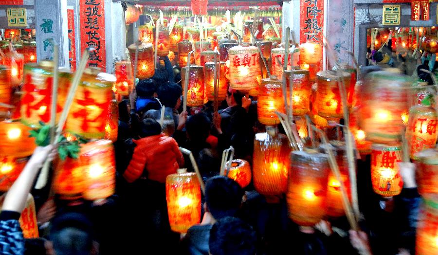 Residents attend an annual lantern parade in Nanshaxiang Village of Shantou, south China's Guangdong Province, Feb. 28, 2013. Participants of the festivity hold lanterns bearing their family names as they proceed through the village. They believe the village's lantern parade, which has existed for centuries, could bring good harvest and fortune. (Xinhua/Xu Ming)