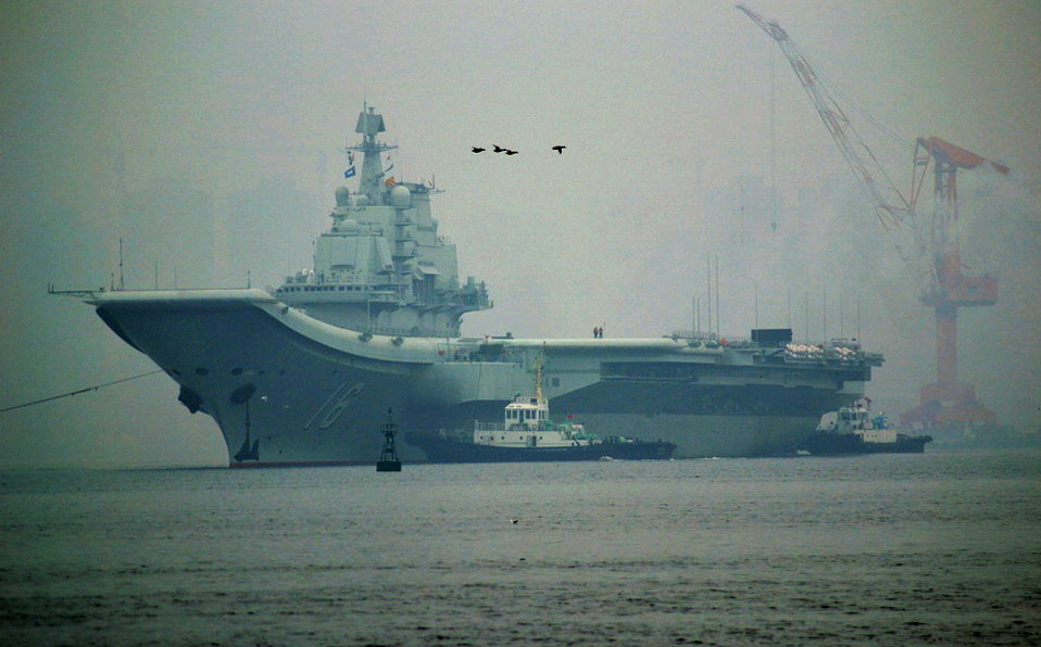China's aircraft carrier anchors in military port 