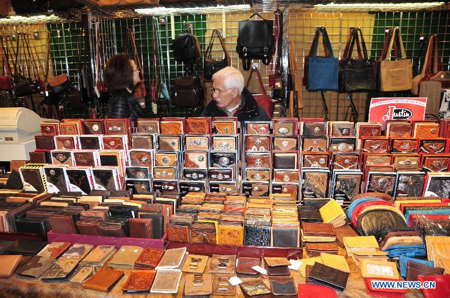 Some wallets and bags made of leather are shown in a booth in Houston, the United States, Feb. 28, 2013. Houston Live Stock Show and Rodeo is held during Feb. 25 to March 17 in Reliant Park in Houston, which is a city of rodeo culture. The rodeo was held yearly since 1932, and has become the biggest rodeo in the world. (Xinhua/Zhang Yongxing) 