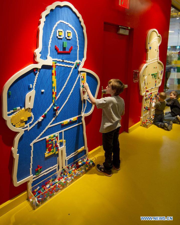 A boy works on his brick creations at Legoland Discovery Centre in Toronto, Canada, March 1, 2013. Canada's first Legoland Discovery Centre opened to the public on Friday.(Xinhua/Zou Zheng)