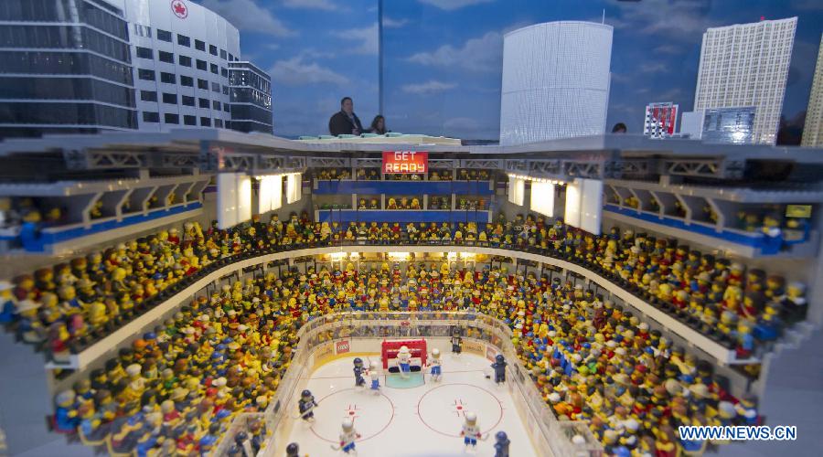 Visitors admire a hockey arena model built by bricks at Legoland Discovery Centre in Toronto, Canada, March 1, 2013. Canada's first Legoland Discovery Centre opened to the public on Friday. (Xinhua/Zou Zheng)