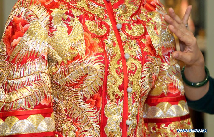 Photo taken on March 2, 2013 shows a wedding dress designed by Guo Pei presented at the "Chinese Bride" flagship store in No. 22 Waitan in Shanghai, east China. A wedding dress show was held by Guo Pei, the owner of the flagship store "Chinese Bride" and also a prominent designer who has created ceremonial dresses for both the CCTV Spring Festival Gala and the 2008 Beijing Olympics. (Xinhua/Zhang Ming) 