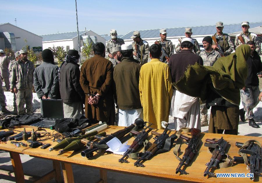 Taliban fighters are handcuffed in Nangarhar province, eastern Afghanistan, on March 2, 2013. Afghan border police captured seven Taliban fighters with their ammunition during a operation in Nangarhar province on Saturday. (Xinhua/Tahir Safi)