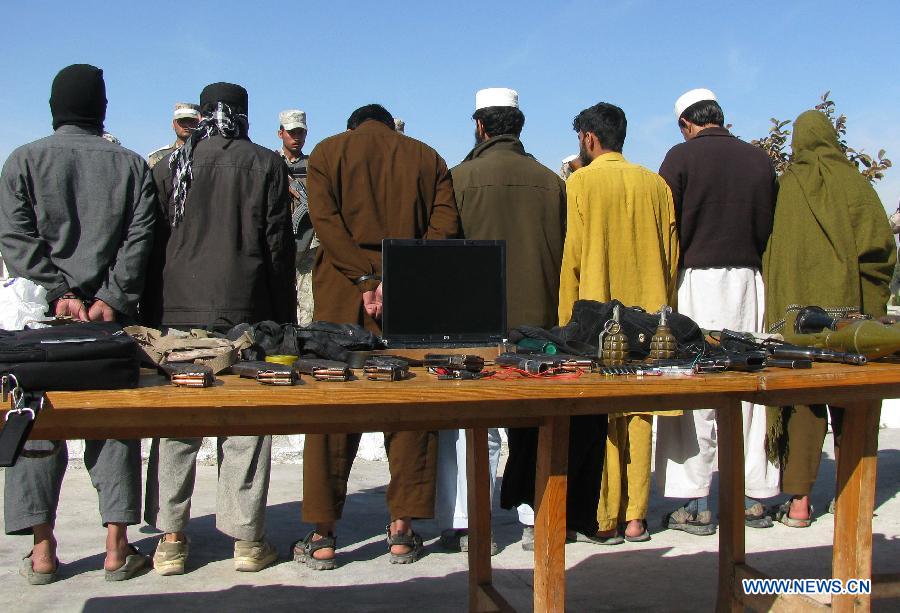 Taliban fighters are handcuffed in Nangarhar province, eastern Afghanistan, on March 2, 2013. Afghan border police captured seven Taliban fighters with their ammunition during a operation in Nangarhar province on Saturday. (Xinhua/Tahir Safi) 
