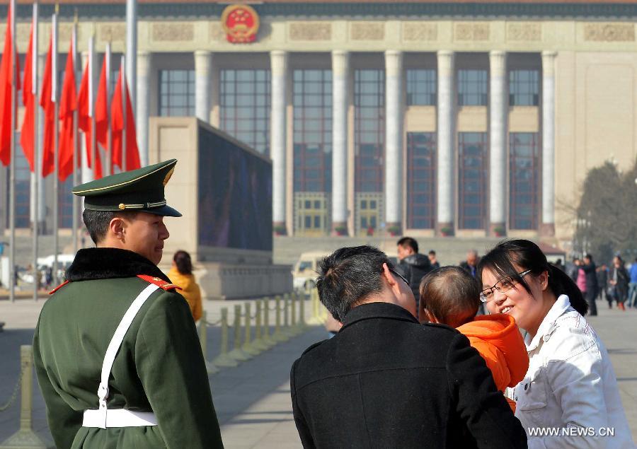 A guard looks on as tourists visit the Tian'anmen Square in Beijing, capital of China, March 3, 2013. The first session of the 12th National Committee of the Chinese People's Political Consultative Conference (CPPCC) is to open on March 3. (Xinhua/Wang Song)