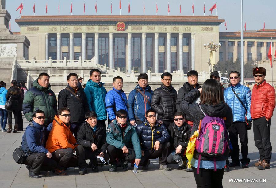 Tourists from South Korea pose for a group photo at the Tian'anmen Square in Beijing, capital of China, March 3, 2013. The first session of the 12th National Committee of the Chinese People's Political Consultative Conference (CPPCC) is to open on March 3. (Xinhua/Wang Song)