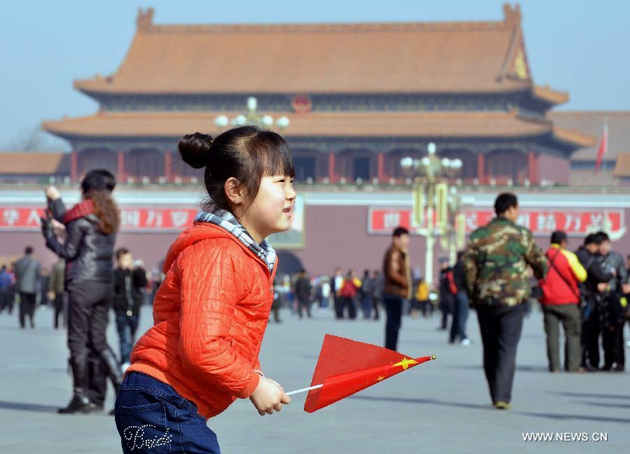 A girl enjoys the sunshine at the Tian'anmen Square in Beijing, capital of China, March 3, 2013. The first session of the 12th National Committee of the Chinese People's Political Consultative Conference (CPPCC) is to open on March 3. (Xinhua/Wang Song)