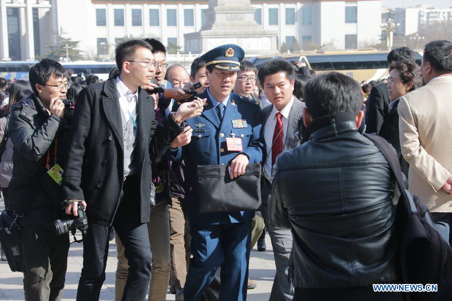 Zhu Heping (C), a member of the 12th National Committee of the Chinese People's Political Consultative Conference (CPPCC), arrives at the Tian'anmen Square in Beijing, capital of China, March 3, 2013. The first session of the 12th CPPCC National Committee is to open on March 3. (Xinhua/Li Gang)
