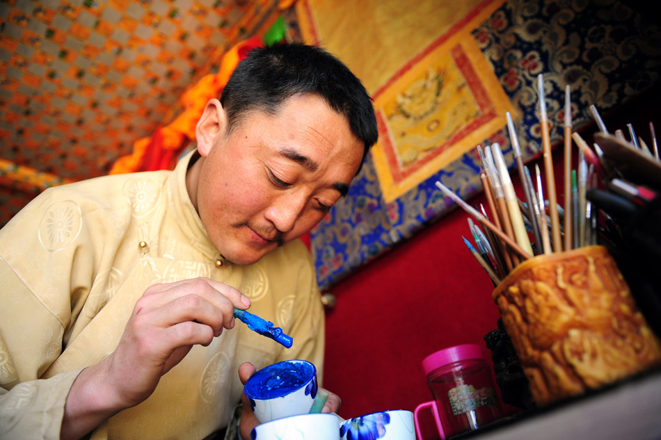 A young Tangka painter works in his studio in Gannan, Gansu on Feb. 23, 2013. (Xinhua/Zhang Meng)