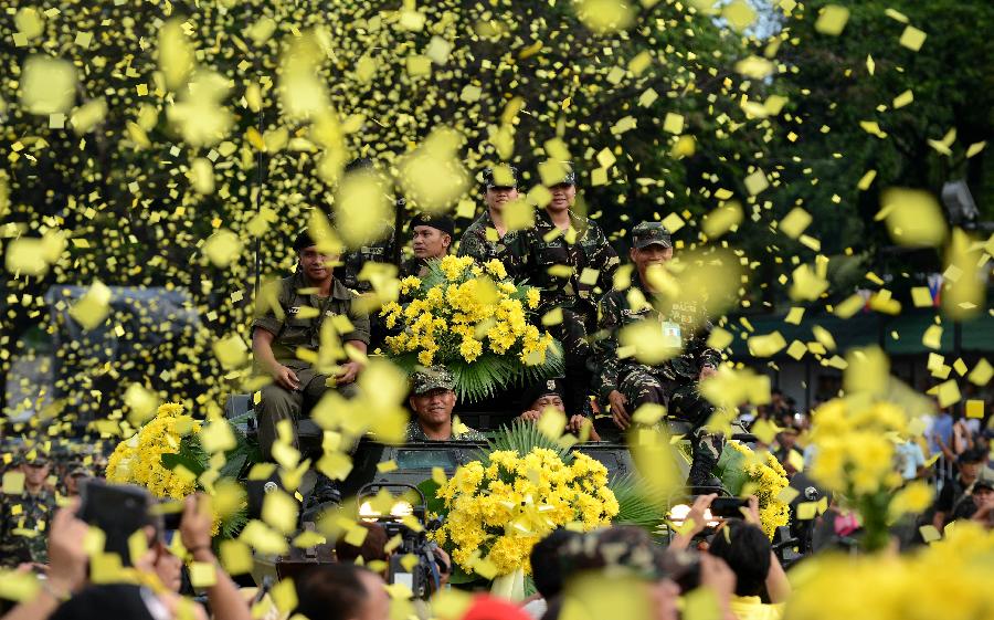 Confetti showers soldiers as they wave from the top of an armoured personnel carrier while re-enacting scenes during the 27th anniversary celebration of the EDSA Revolution at the People Power Monument in Quezon City, metro Manila February 25, 2013. President Benigno Aquino, who has been in power since 2010, led the celebrations for the 27th anniversary of the "People Power Revolution" that drove late dictator Ferdinand Marcos and his family into exile.  (Xinhua/Reuters Photo)