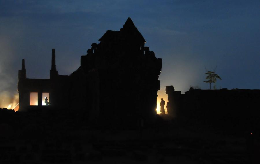 A monk walks near Nandi Hall at Vat Phou temple in Champasak in southern Laos, Feb. 24, 2013. This year's Vat Phou festival was held from Feb. 20 to 25 and reached the climax on Feb. 25 when full moon appeared. Some 100,000 people are expected to visit Vat Phou temple, a part of UNESCO's World Heritage Vat Phou and Associated Ancient Settlements within the Champasak Cultural Landscape. (Xinhua/Rong Zhongxia)