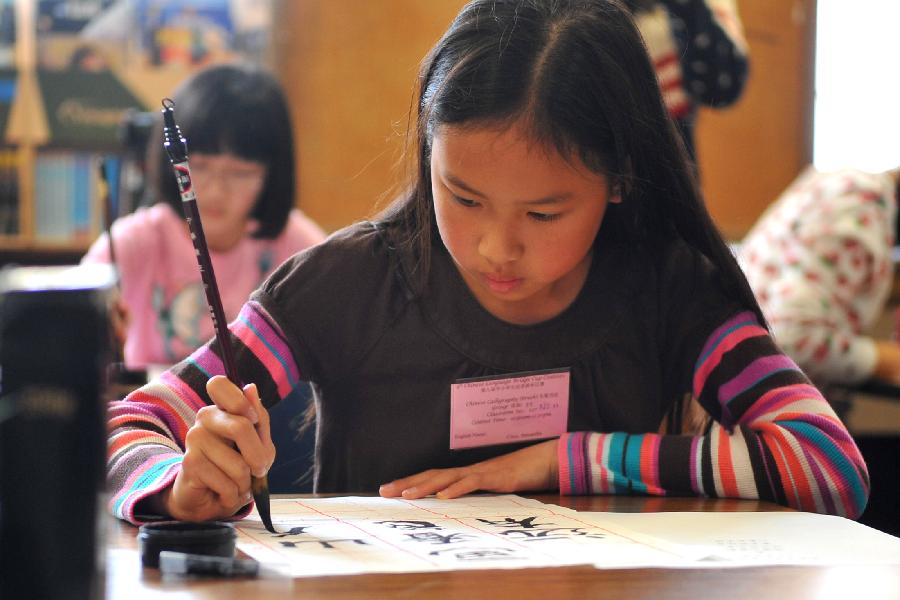 A student takes part in the calligraphy competition of the 9th Chinese Language Bridge Cup Contest in San Francisco, the United States, Mar. 3, 2013. Held by the Confucius Institute of San Francisco State University and San Francisco's Unified School District, the contest kicked off on Saturday with the participation of some 1,400 student. (Xinhua/Liu Yilin) 