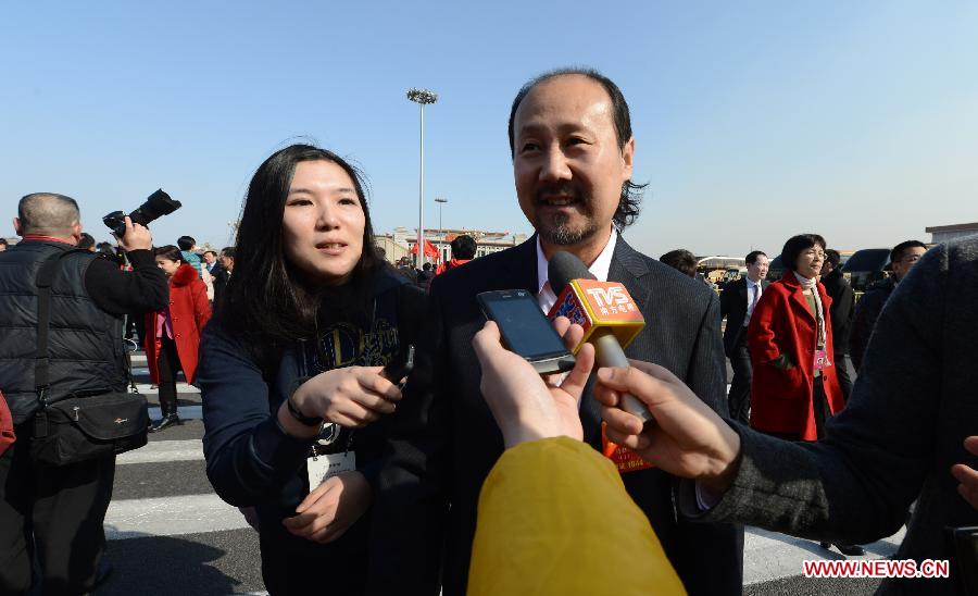Tenggel, a member of the 12th National Committee of the Chinese People's Political Consultative Conference (CPPCC), receives an interview outside the Great Hall of the People in Beijing, capital of China, March 3, 2013. The first session of the 12th CPPCC National Committee opened in Beijing on March 3. (Xinhua/Qin Qing)