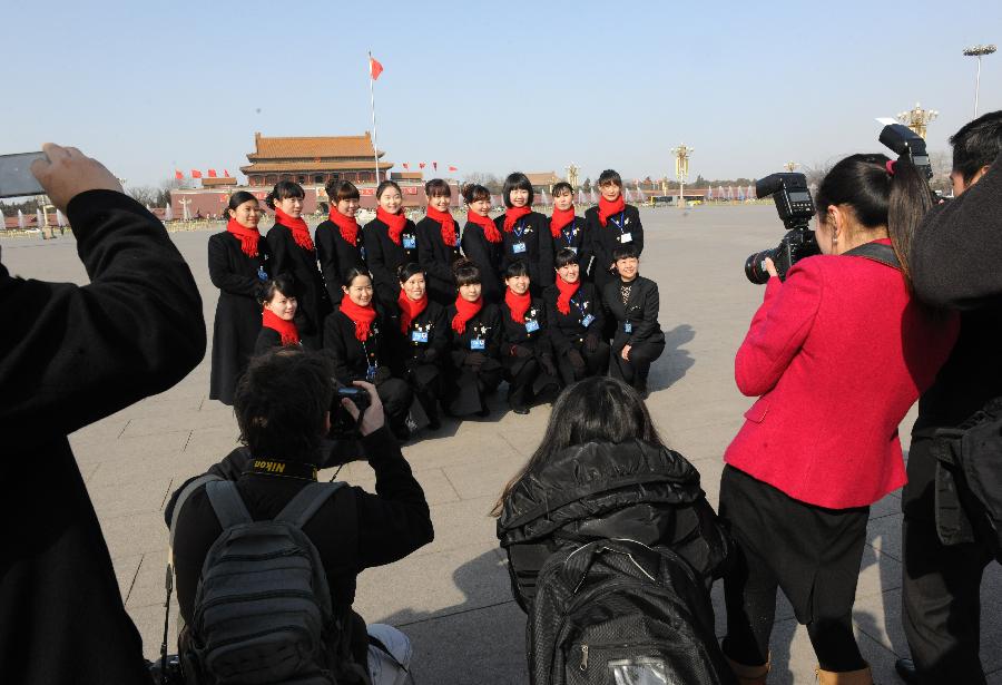 Staff members pose for a group photo at the Tian'anmen Square in Beijing, capital of China, March 3, 2013. The first session of the 12th National Committee of the Chinese People's Political Consultative Conference (CPPCC) opened in Beijing on March 3. (Xinhua/He Junchang) 