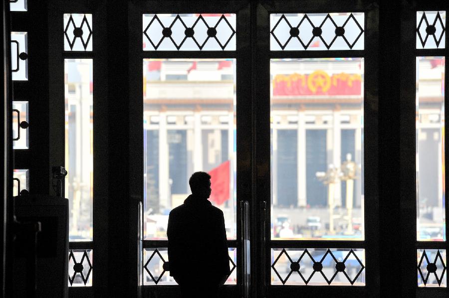 A security man stands guard in the Great Hall of the People in Beijing, capital of China, March 3, 2013. The first session of the 12th National Committee of the Chinese People's Political Consultative Conference (CPPCC) opened at the Great Hall of the People in Beijing on March 3. (Xinhua/Guo Chen) 