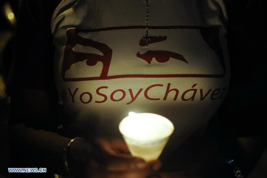 A resident participates in a vigil in support of Venezuelan President Hugo Chavez in front of Caracas' Military Hospital, in Caracas, capital of Venezuela, on Mar. 2, 2013. Venezuela's ailing President Hugo Chavez is undergoing chemotherapy in the capital's military hospital, Vice President Nicolas Maduro said Friday, calling for respect for Chavez and his family. (Xinhua/Mauricio Valenzuela) 