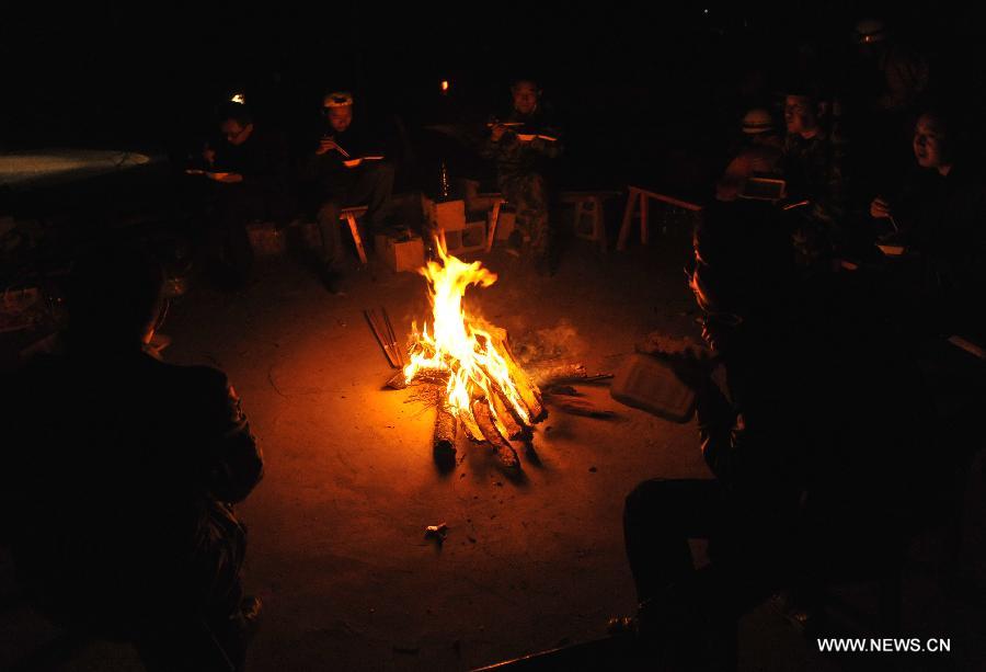 Locals surround a campfire at a blackout night after a 5.5-magnitude earthquake in Eryuan County of Dali Bai Autonomous Prefecture, southwest China's Yunnan Province, on March 3, 2013. The number of people confirmed injured by a 5.5-magnitude earthquake that hit southwest China's Yunnan Province on Sunday afternoon has risen to 30, local authorities have said. (Xinhua/Lin Yiguang) 