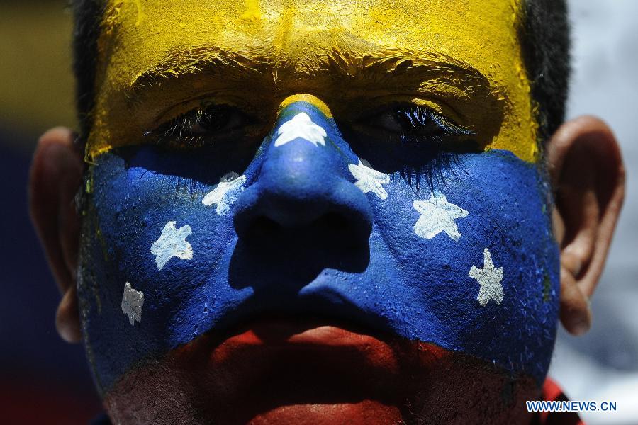 A man with the Venezuelan flag painted on his face attends a protest organized by students and opposers to the Venezuelan President Hugo Chavez in Caracas, capital of Venezuela, on March 3, 2013. Protestors demanded information about Chavez' state of health. Venezuelan President Hugo Chavez was hospitalized at the Carlos Arvelo Military Hospital since Feb. 18, according to the local press. (Xinhua/Mauricio Valenzuela) 