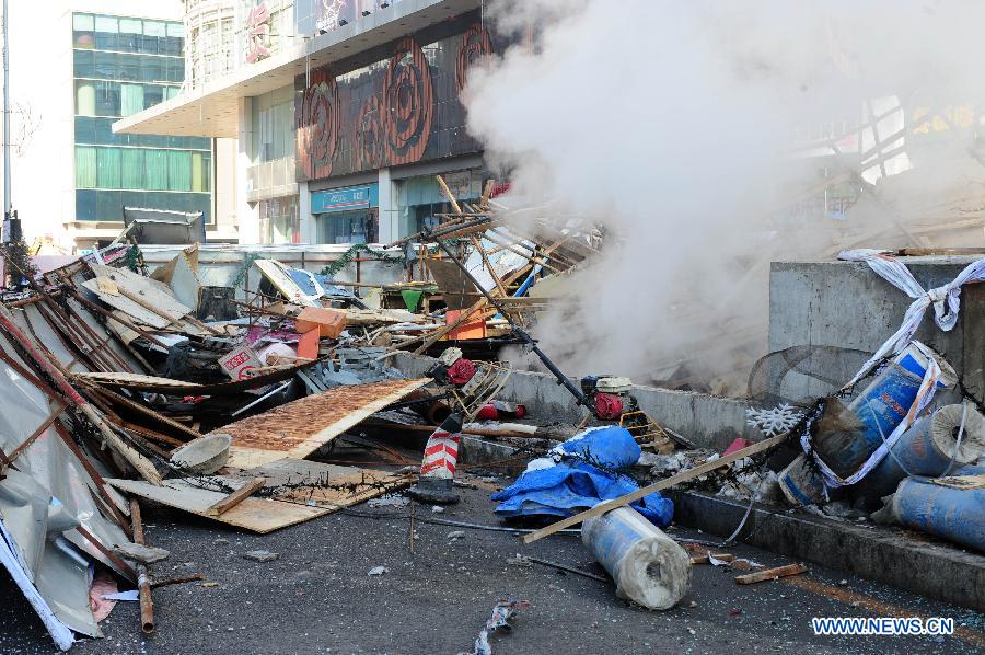 Wrecks are seen at the accident site after an explosion hit an underground passage in front of a shopping mall in Shenyang, capital of northeast China's Liaoning Province, March 4, 2013. It was not immediately known if there are any casualties. The shock wave of the blast at about 9 a.m. could be felt one kilometer away, local residents said. (Xinhua/Pan Yulong)