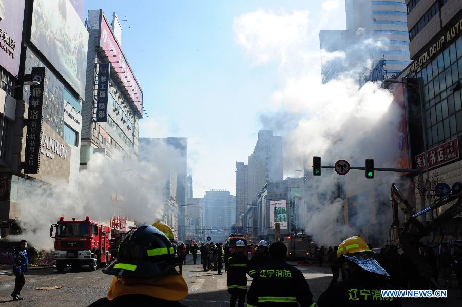 Rescuers work at the accident site after an explosion hit an underground passage in front of a shopping mall in Shenyang, capital of northeast China's Liaoning Province, March 4, 2013. It was not immediately known if there are any casualties. The shock wave of the blast at about 9 a.m. on Monday could be felt one kilometer away, local residents said. (Xinhua/Pan Yulong)