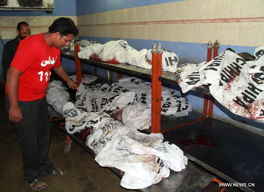 A man tries to identify the body of his relative at a hospital in southern Pakistani port city of Karachi, March 4, 2013. At least 45 people were killed and 150 others injured when twin blasts hit a residential area in Pakistan's southern port city of Karachi on Sunday night. (Xinhua/Arshad) 