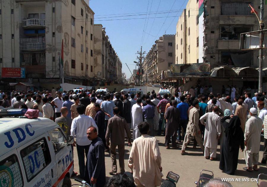 Pakistani people gather at the bomb blast site in southern Pakistani port city of Karachi, March 4, 2013. At least 45 people were killed and 150 others injured when twin blasts hit a residential area in Pakistan's southern port city of Karachi on Sunday night. (Xinhua/Arshad) 