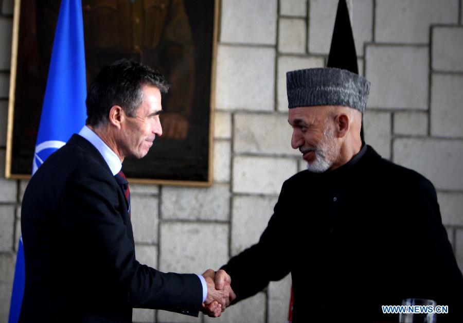 NATO Secretary General Anders Fogh Rasmussen (L) shakes hands with Afghan President Hamid Karzai after a joint press conference in Kabul, Afghanistan on March 4, 2013. Afghan President Hamid Karzai on Monday termed terrorism as the common enemy of Afghanistan and Pakistan and sought firm anti-terror support from Islamabad. (Xinhua/Ahmad) 