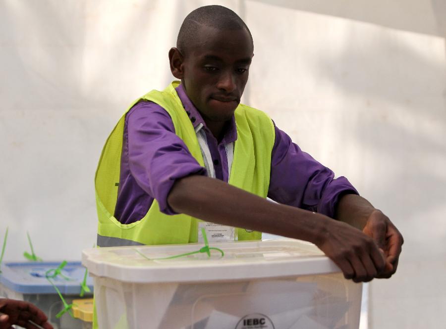 A staff worker of Kenya's Independent Electoral and Boundaries Commission (IEBC) opens a ballot paper box at a counting station in Nairobi, Kenya, March 4, 2013. Millions of Kenyans turned up early Monday to vote in the historic general elections after independence and in the first national exercise under new constitution after the a disputed polls in 2007. According to the constitution, IEBC will have seven days to officially announce the results, but the country's next president is expected to be known by Monday evening or Tuesday. (Xinhua/Meng Chenguang) 