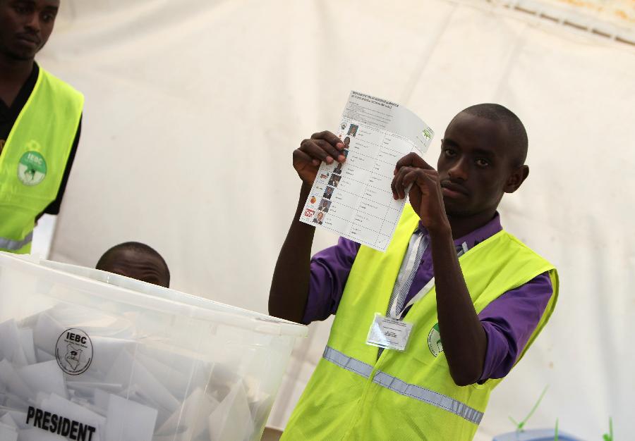 A staff worker of Kenya's Independent Electoral and Boundaries Commission (IEBC) shows a ballot paper at a counting station in Nairobi, Kenya, March 4, 2013. Millions of Kenyans turned up early Monday to vote in the historic general elections after independence and in the first national exercise under new constitution after the a disputed polls in 2007. According to the constitution, IEBC will have seven days to officially announce the results, but the country's next president is expected to be known by Monday evening or Tuesday. (Xinhua/Meng Chenguang)