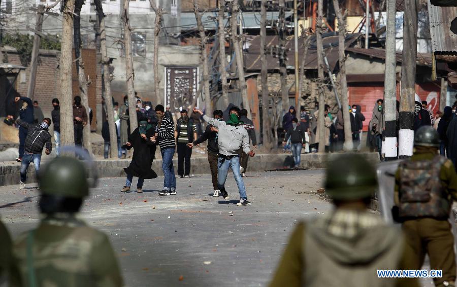 Kashmiri protesters throw stones at Indian paramilitary soldiers and police during a protest in Srinagar, summer capital of Indian-controlled Kashmir, March 4, 2013. Tension gripped Muslim majority areas of Indian-controlled Kashmir on Monday following the death of a Kashmiri student in Indian state of Andhra Pradesh. (Xinhua/Javed Dar) 