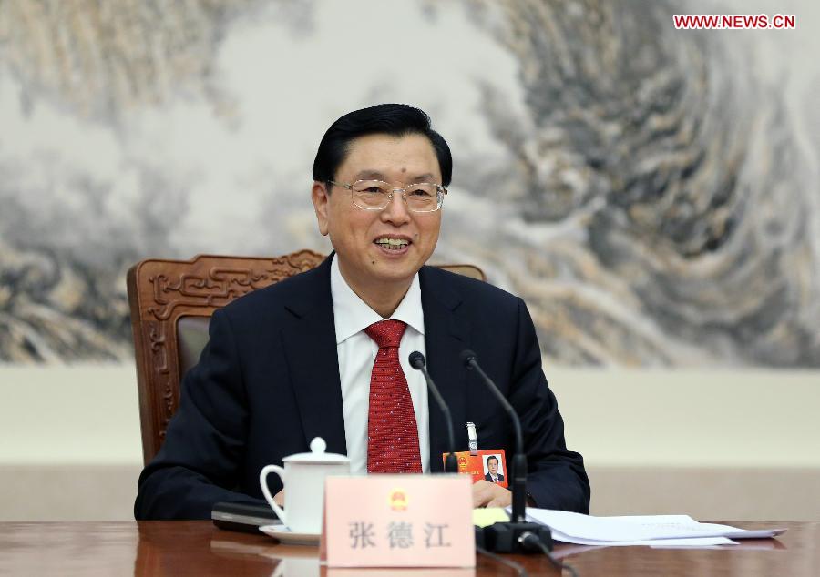 Zhang Dejiang, executive chairperson of the presidium of the first session of the 12th National People's Congress (NPC), presides over the first meeting of the presidium's executive chairpersons at the Great Hall of the People in Beijing, capital of China, March 4, 2013. (Xinhua/Lan Hongguang)