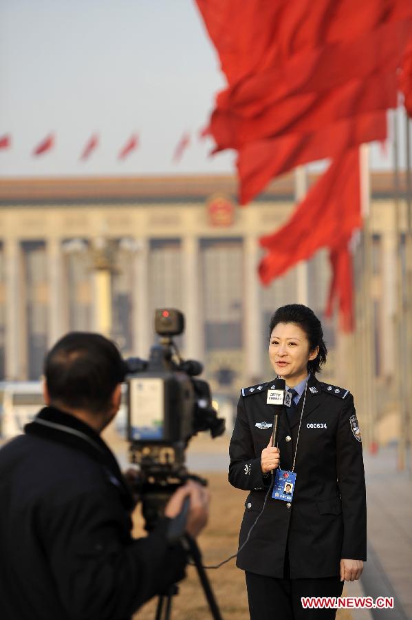 A journalist works at the Tian'anmen Square in Beijing, capital of China, March 5, 2013. The first session of the 12th National People's Congress (NPC) will open at the Great Hall of the People in Beijing on March 5. (Xinhua/Wang Peng)
