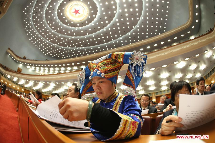 A deputy listens during the opening meeting of the first session of the 12th National People's Congress (NPC) at the Great Hall of the People in Beijing, capital of China, March 5, 2013. (Xinhua/Chen Jianli) 