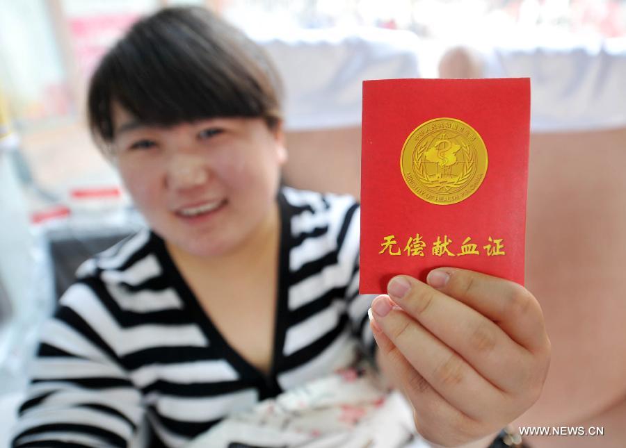 A citizen shows her certificate after donating blood to mark the Lei Feng Day in Yinchuan, capital of northwest China's Ningxia Hui Autonomous Region, March 5, 2013. Lei Feng, a young Chinese soldier in the 1960s, is known for devoting his spare time and money to helping the needy. Lei died after being hit by a falling pole while helping a fellow soldier direct a truck on Aug. 15, 1962. A year later, Chairman Mao called on the nation to follow Lei's example, and March 5 of every year is designated "Lei Feng Day." (Xinhua/Peng Zhaozhi)