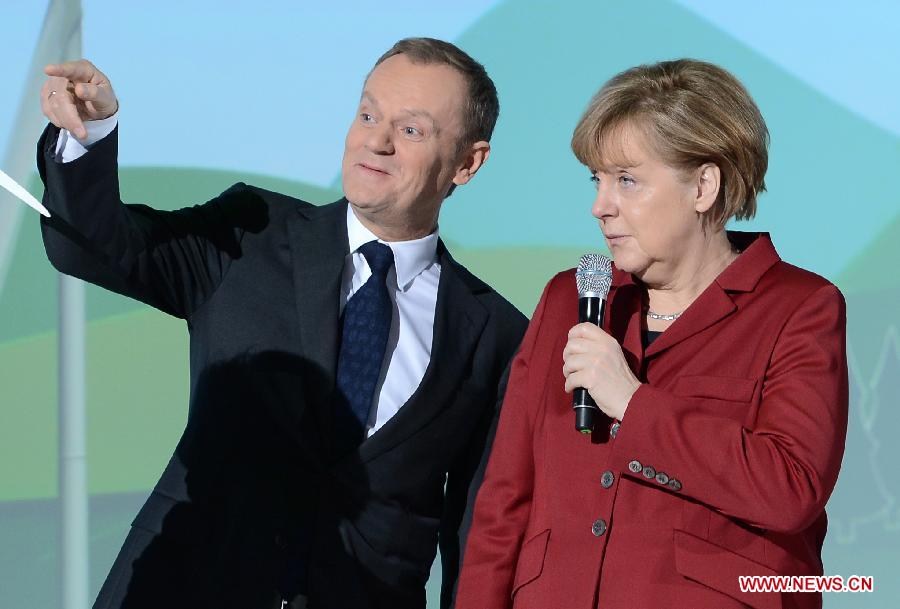 Polish Prime Minister Donald Tusk (L) and German Chancellor Angela Merkel visit the showcase of IBM at the CeBIT tech fair in Hanover, Germany, March 5, 2013. CeBIT, the world's leading exhibition in the communication and information technology industry, opened Monday evening in Hanover, Germany. (Xinhua/Ma Ning) 