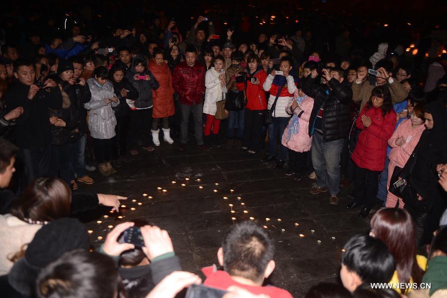 Local residents gather to mourn for the baby who was strangled to death by a car stealer in Changchun, capital of northeast China's Jilin Province, March 5, 2013. Zhou Xijun, 48, native of the Gongzhuling City of Jilin, stole a gray Toyota RAV4 SUV on March 4 in Changchun. Zhou drove the jeep on the highway and found a baby on the backseat. He parked the jeep on the roadside and then strangled the baby. (Xinhua/Lin Hong)