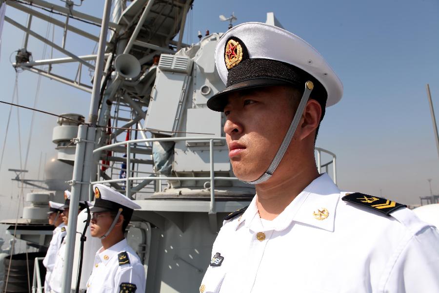 The picture shows the well-dressed officers and men of the 14th Chinese naval escort taskforce line up along the side of the ship. (Xinhua/Rao Rao)