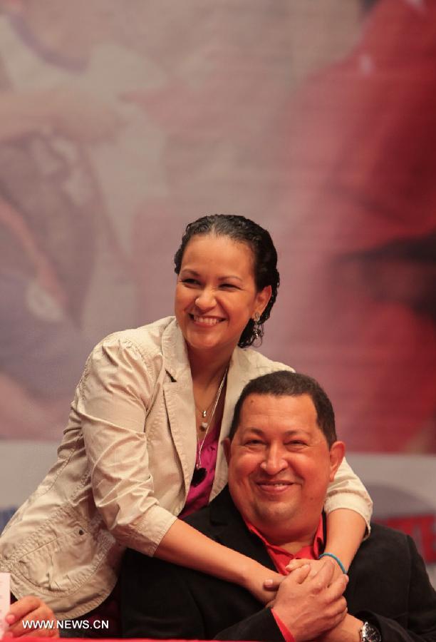 File photo taken on Feb. 23, 2012 shows Venezuelan President Hugo Chavez and his daughter Rosa posing during a party in Caracas, Venezuela. Venezuelan government confirmed President Hugo Chavez's death on March 5, 2013. (Xinhua) 