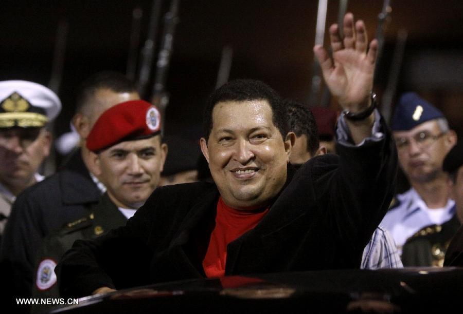 File photo taken on March 16, 2012 shows Venezuelan President Hugo Chavez greeting his supporters on his arrival at the Simon Bolivar International Airport of Maiquetia, Caracas, Venezuela. Venezuelan government confirmed President Hugo Chavez's death on March 5, 2013. (Xinhua) 