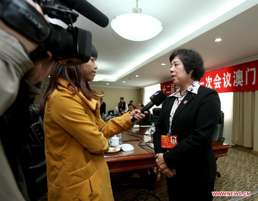 Leong Lok Wa (R), a deputy to the 12th National People's Congress (NPC) from the Macao Special Administrative Region, receives an interview in Beijing, capital of China, March 6, 2013. A discussion held by the Macao delegation to the first session of the 12th NPC was open to media on March 6. (Xinhua/Chen Jianli)