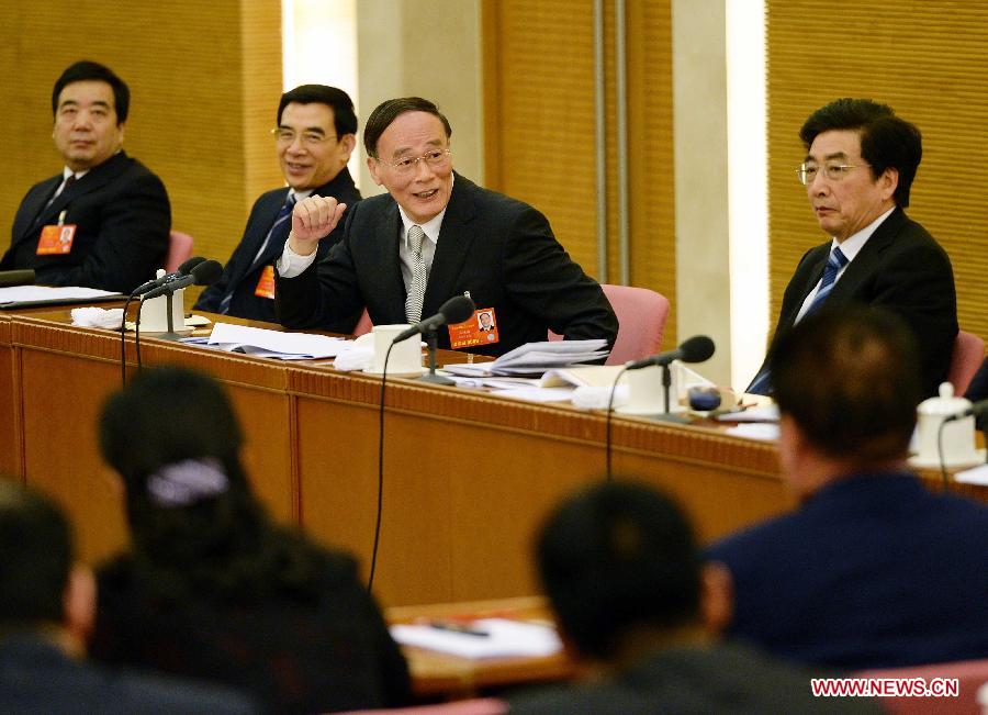 Wang Qishan (3rd L), a member of the Standing Committee of the Political Bureau of the Communist Party of China (CPC) Central Committee, joins a panel discussion with deputies from Beijing, who attend the first session of the 12th National People's Congress (NPC), in Beijing, capital of China, March 6, 2013. (Xinhua/Li Tao)