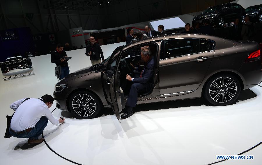 A visitor tries the Qoros 3 sedan on the press day of the 83rd Geneva International Motor Show in Geneva, Switzerland, on March 6, 2013. (Xinhua/Wang Siwei) 