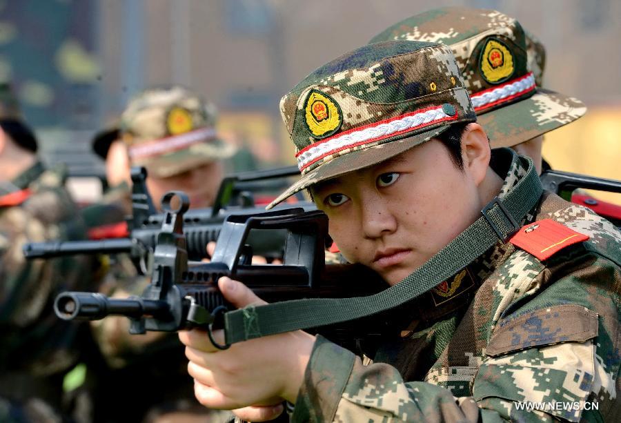 A newly-recruited female soldier of the Border Control Corps of Hebei Public Security receives military training in Shijiazhuang, capital of north China's Hebei Province, March 6, 2013. (Xinhua/Yang Shiyao)