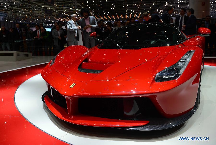 Visitors view the LaFerrari car on the press day of the 83rd Geneva International Motor Show in Geneva, Switzerland, on March 6, 2013. (Xinhua/Wang Siwei) 