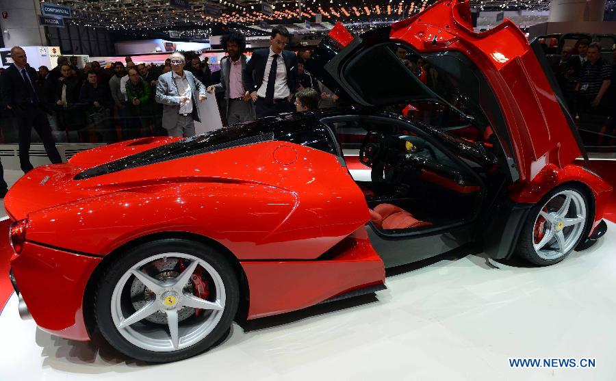 Visitors view the LaFerrari car on the press day of the 83rd Geneva International Motor Show in Geneva, Switzerland, on March 6, 2013. (Xinhua/Wang Siwei)  