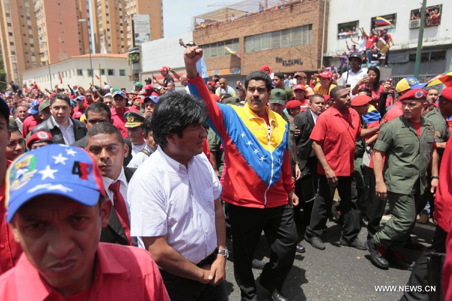 Venezuelan Vice President Nicolas Maduro (C) and Bolivian President Evo Morales (2nd L Front) lead the funeral procession in honor of Venezuelan President Hugo Chavez on the streets of Caracas, capital of Venezuela, on March 6, 2013. On Tuesday afternoon, Venezuelan President, Hugo Chavez, died after fighting for almost two years with a cancer disease. The body of Chavez is moved from the health center to the Military Academy in southern Caracas, inside Tiuna's Fort. (Xinhua/AVN)