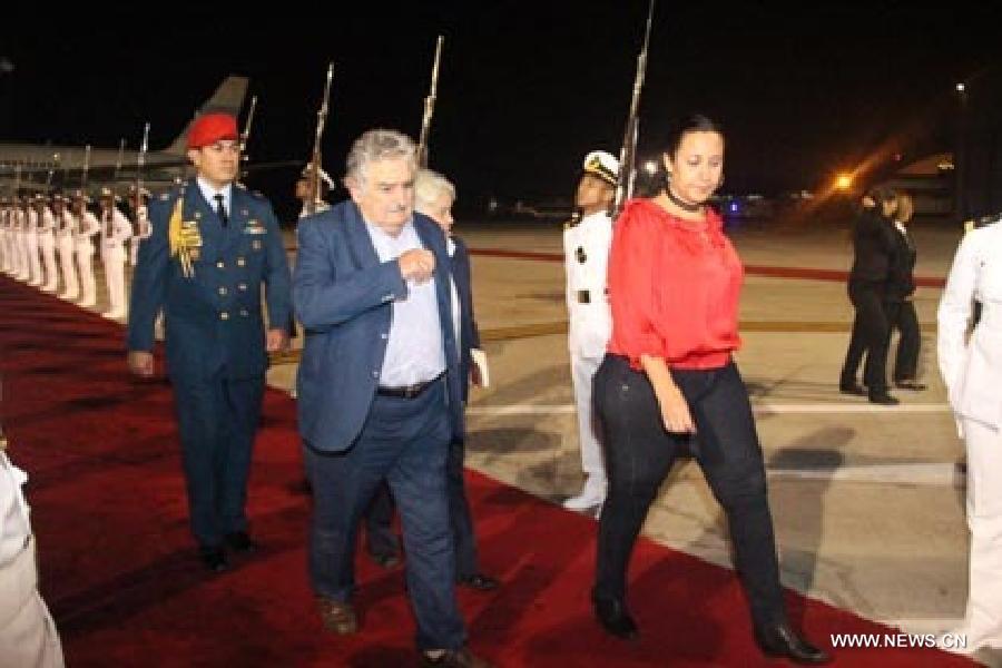 Image provided by People's Ministry of Foreign Affairs of Venezuela, shows Uruguayan President Jose Mujica (C) arriving at Caracas city, capital of Venezuela, on March 6, 2013. Venezuelan President Hugo Chavez died of cancer on Tuesday. (Xinhua/People's Ministry of Foreign Affairs of Venezuela)